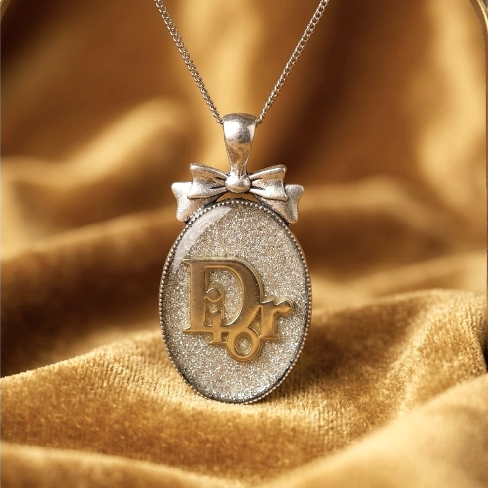 Handmade Designer-Inspired Medallion Pendant with bow: Silver with gold inlay.
